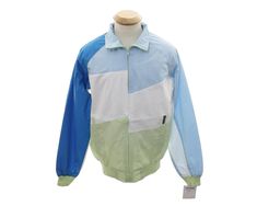 Unisex Members Only jacket in shaded sky and medium blue, white and lime green diagonal off center color block print lightweight cotton and polyester. Zipper closure with stand up or fold over collar, two lower pockets. Rib knit waistline and cuffs. Chest and back white paneling features mesh overlay. Identical to 1980's style Members Only jackets (made in 2001). Label reads Mens Small (fits 34 to 36 chest, 33 sleeve). Made for a man but would work just as well on a woman. New/unworn. Fitted Casual Cotton Track Jacket, Patchwork Nylon Windbreaker For Spring, Green Color Block Outerwear For Spring, White Cotton Track Jacket For Spring, Casual Color Block Track Jacket For Spring, Blue Nylon Track Jacket For Spring, Retro Blue Windbreaker For Spring, Sporty Patchwork Track Jacket For Spring, Spring Cotton Windbreaker With Patchwork