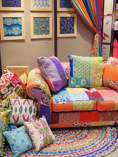 a colorful couch sitting on top of a rug covered floor