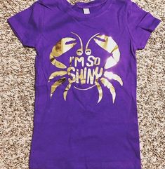 a purple shirt that says i'm so shiny on the front with gold foil