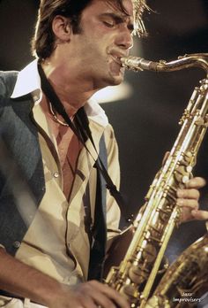 a man is playing the saxophone on stage