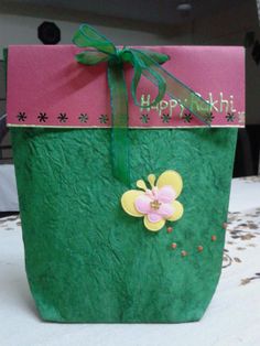 a green bag with pink and yellow flowers on it