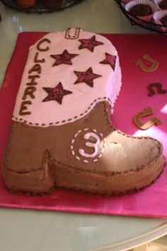 a cake shaped like a cowboy boot with stars on the top and number 5 on the bottom