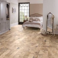 a bedroom with wood flooring and white walls