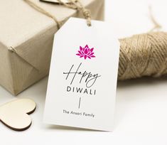 a tag with the words happy diwali on it next to some twine