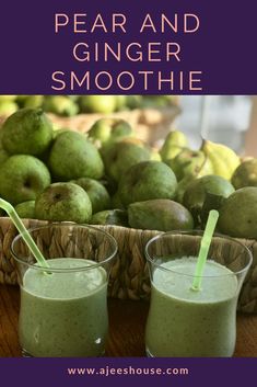 pear and ginger smoothie in two glasses with straws next to the basket full of fruit