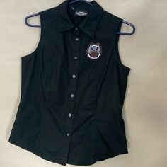 Women’s Harley Davidson Button Up Sleeveless Blouse Size Medium Never Worn It Was A Gift That Never Fit I Still Hate To Part With It Casual Sleeveless Vest With Snap Buttons, Sleeveless Tops With Snap Buttons For Work, Sleeveless Cotton Vest With Snap Buttons, Cotton Sleeveless Vest With Snap Buttons, Black Casual Buttoned Tank Top, Casual Black Buttoned Tank Top, Casual Black Tank Top With Button Closure, Cotton Tank Top With Button Closure For Work, Black Cotton Vest With Buttons