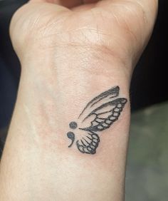 a small tattoo on the wrist of a person with a butterfly on it's arm