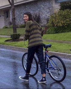 a woman riding a bike in the rain