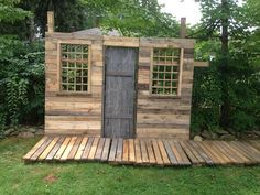 an outhouse made from pallet wood in the yard