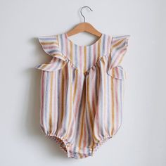 Made from Organic Cotton: An eco-friendly, breathable, and hypoallergenic fabric that’s gentle on delicate skin. Care Instructions: Machine wash on a gentle cycle, tumble dry on low. A Thoughtful Gift: Ideal for birthdays, holidays, or any day you want to make extra special for the little one in your life. Cute Sleeveless Ruffled Bodysuit, Cute Sleeveless Bodysuit With Ruffles, Sleeveless Ruffles Bodysuit For Playtime, Sleeveless Ruffled Bodysuit For Playtime, Summer Sleeveless Onesie With Ruffles, Spring Sleeveless Bodysuit, Sleeveless Spring Bodysuit, Sleeveless Jumpsuits And Rompers With Ruffles For Playtime, Cute Sleeveless Ruffled Onesie