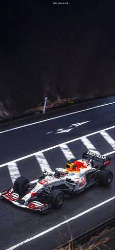 a red and white race car driving down the road