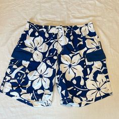 Ron Jon Size Xxl Blue And White Flower Pattern Good Condition Never Worn Mark On Back Netting Is Cut See Photo Above Will Ship Asap Blue Swimwear With Pockets For Spring, Casual Blue Short Sleeve Swimwear, White Flower Pattern, Ron Jon, Ron Jon Surf Shop, Swim Shoes, Blue Hawaiian, Mens Boardshorts, Levi Jeans 501