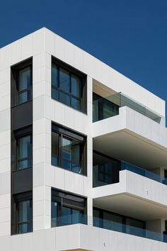 an apartment building with multiple balconies and windows