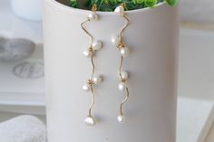 PEARL DANGLE EARRINGS, Freshwater Pearls Chandeliers, Ivory Pearl Minimalist Earrings, Wedding Pearl Earrings, Dainty Long Bridal Earrings Details of item: Metal: Brass - nickel free Plating Finish: 24K Gold Plated - Nickel Free Gemstone: freshwater pearls Earrings Size: 4 inches long The earrings will be packed in a gift box. FOR MY EARRINGS COLLECTION HERE: https://www.etsy.com/il-en/shop/rebekajewelry?section_id=14222612&ref=shopsection_leftnav_3 TO GET TO MY ETSY SHOP: https://www.etsy.c Dainty White Pearl Drop Chandelier Earrings, Graceful White Pearl Bridal Earrings, Cream Dangle Jewelry For Wedding, Minimalist White Bridal Earrings For Formal Occasions, White Long Drop Chandelier Earrings For Wedding, Graceful White Dangle Bridal Earrings, White Dangle Linear Earrings For Wedding, Elegant White Linear Earrings For Wedding, Elegant White Chandelier Earrings