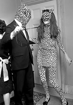 three people dressed up in animal print outfits