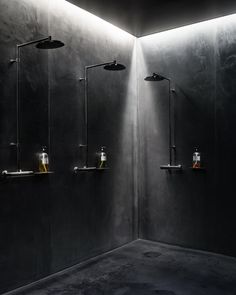 a black and white photo of a bathroom with lights on the shower head is shown