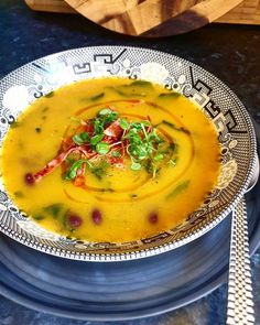 a bowl filled with soup on top of a table