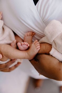 a woman holding a baby in her arms