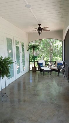 a screen shot of a porch with chairs and a ceiling fan