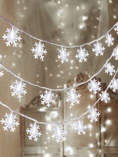 snowflake lights are hanging from the ceiling