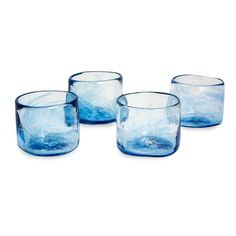 three blue glass cups sitting next to each other