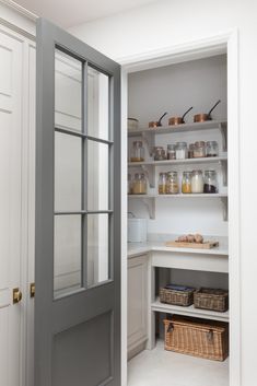 an open pantry with glass doors and shelves