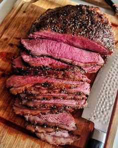 sliced roast beef on cutting board with knife