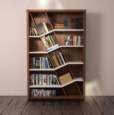 a bookshelf with many books on it in a room that has wood floors and white walls