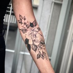 a person with a flower tattoo on their arm