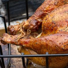 a whole chicken sitting on top of a grill