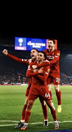 the soccer players are celebrating on the field