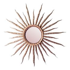 a mirror that is made out of wood and has spikes on the bottom of it