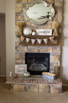 a living room with a brick fireplace decorated for thanksgiving and decorations on the mantel