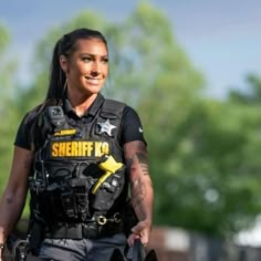 a woman police officer is smiling for the camera