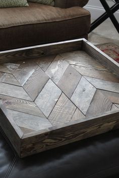 a wooden tray sitting on top of a leather couch