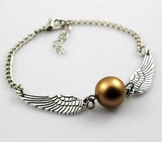 a bracelet with an angel wing charm and a pearl bead on the end of it