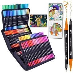 an assortment of colored pencils and markers in a case next to a coloring book