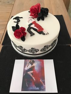 a white cake with red roses on top