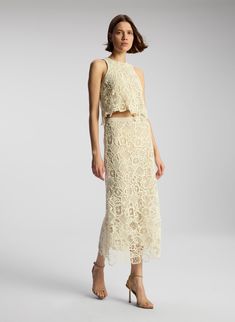 The Shay Skirt is crafted from our custom Garcia lace in a warm white hue. This midi skirt features a pull-on waistband and tonal lining that accentuates the natural edges of the lace. This style runs true to size. Shop Bottoms. Styling Tip: Pair with the matching Lena Top and flat sandals for relaxed bridal style. High Neck Sleeveless Top, Natural Edges, Lace Midi Skirt, Shop Tops, Stylish Party, High Neck Sleeveless, Stylish Party Dresses, Lace Midi, 2024 Vision