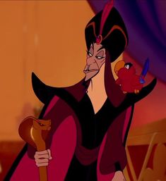 the evil queen from disney's beauty and the beast is holding an apple in her hand