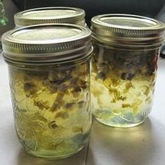 three jars filled with food sitting on top of a table