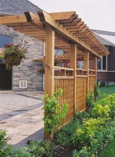 a wooden pergola in front of a house