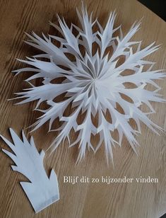 a paper snowflake sitting on top of a wooden table