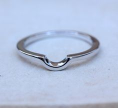 Here are our curved wedding bands This ring has been designed to curve around the setting of the below ring, this helps both rings to sit as flush as possible: https://www.etsy.com/uk/listing/279124136 Band width: 1.75mm Band height: 1.6mm Gap inside curved part of ring is 5mm wide by 2.5mm deep. We produce this ring in two metals for you to choose from: Sterling silver: This is a very popular material, known for its great durability. Silver pieces are known to require no maintenance and will la Minimalist Curved Wedding Jewelry, Curved Wedding Rings With Polished Finish, Minimalist Curved Wedding Rings, Modern Curved Jewelry For Wedding, Modern Curved Wedding Jewelry, Modern Curved Wedding Rings, Curved Jewelry With Polished Finish For Anniversary, Band For Oval Ring, Wedding Band For Oval Ring