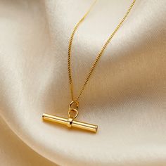 We've taken a classic design and reinvented it to create our luxury Mini 9ct gold T Bar Necklace. This beautiful necklace is crafted from 9ct yellow gold. A gorgeous take on the classic T Bar necklace featuring a dainty T Bar pendant with a rounded design. The perfect gift for someone special or a little treat for yourself. Comes suspended on 18" 9ct gold chain. 9ct yellow gold. T Bar Necklace, Posh Totty, Nickel Allergy, Bar Jewelry, Mini Gold, Creating Jewelry, Bar Pendant, Necklace Online, Beautiful Necklace