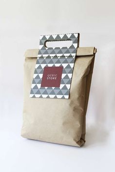 a brown paper bag with a red tag on the front and bottom, sitting against a white background