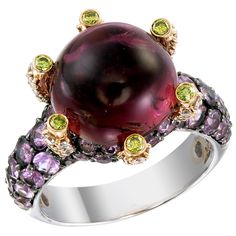 A 10.40-carat round Pink Tourmaline sits high like a colorful crystal ball on a 18k gold and palladium ring protected by 0.14-carat Yellow Diamonds. The ring’s surface is paved with 2.70-carat of Pink Sapphire and 0.59-carat of White Diamonds. This ring, as with all Zorab Creation pieces, are sent with a unique serial number to validate its authenticity. Ring Size 7 1/4 Palladium Ring, Art Nouveau Fashion, Red Tourmaline, Green Tourmaline Ring, Yellow Diamonds, Pink Tourmaline Ring, Jewelry Brands, Ring Displays, Diamond Cocktail Rings