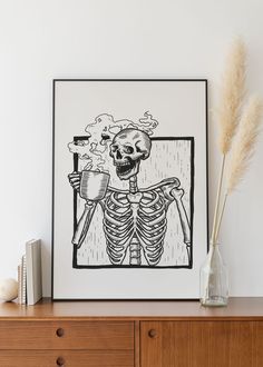 a drawing of a skeleton holding a beak in front of a wooden dresser with two books on it