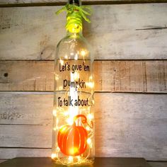 a bottle with lights in it that says let's give em pumpkin to talk about