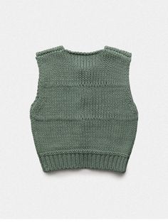 a green knitted vest on a white background